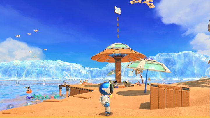 Near the shore there is a large umbrella with some coins and the 3rd puzzle piece floating above it - Astros Playroom: Bot Beach - walkthrough - Cooling Springs - Astros Playroom Guide