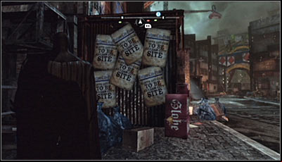 Find the closed hot-dog booth (Bills Hotdogs) and examine its side - Riddles | Industrial District - Industrial District - Batman: Arkham City Game Guide