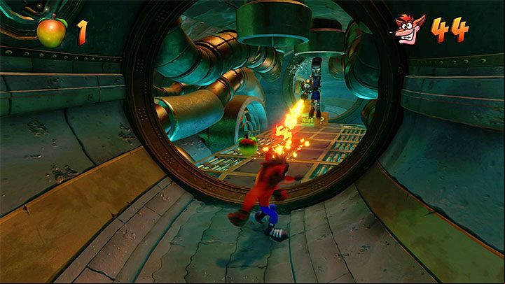 After the stage starts, walk around the nitroglycerine crate and the robots - Sewer or Later | Crash Bandicoot 2 | Levels - Crash Bandicoot 2 - Sewer Warp Room - Crash Bandicoot N. Sane Trilogy Game Guide