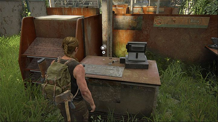 The coin lies on the counter next to one of the cash s - The Last of Us 2: On Foot - collectibles, artefacts, coins - Seattle Day 1 - Abby - The Last of Us 2 Guide