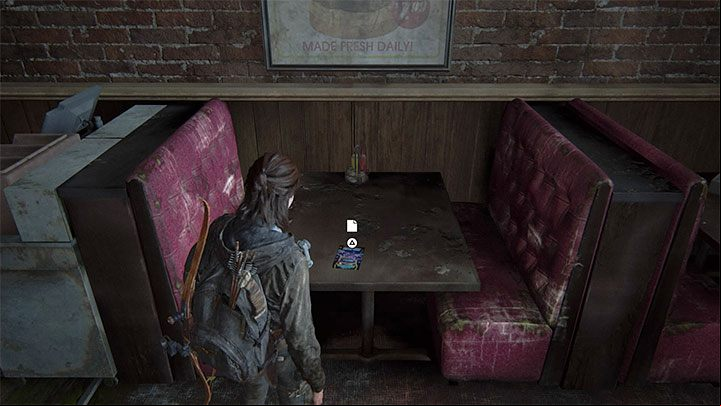 The leaflet sits on one of the tables in the dining area of the arcade - The Last of Us 2: The Flooded City - collectibles, artefacts, coins - Seattle, Day 3 - Ellie - The Last of Us 2 Guide
